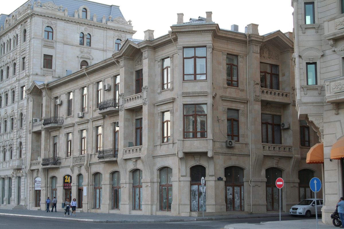 The three-storey stone building at 39 Fizuli Street in Baku, with carved façade details, bay windows and balconies