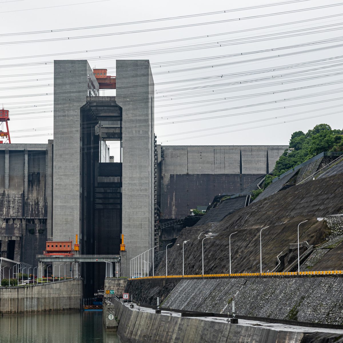 The concrete towers of the Three Gorges ship lift rising above the downstream approach channel, with the lift chamber opening between them