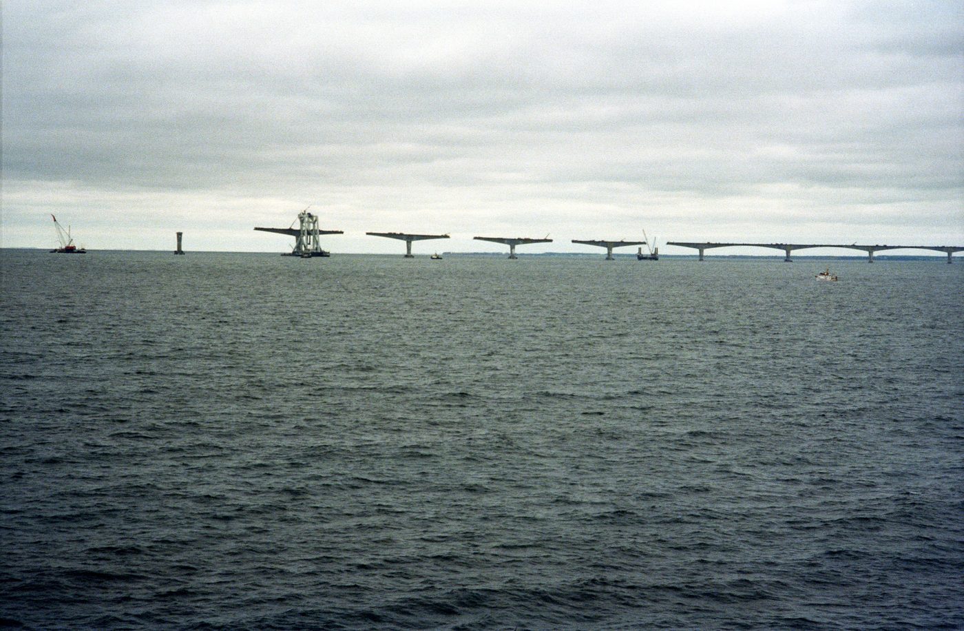 Confederation Bridge under construction over the Northumberland Strait, showing balanced-cantilever pier units in place before the drop-in spans close the gaps